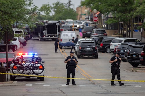 HIGHLAND PARK, IL - JULY 04: First responders take away victims from the scene of a mass shooting at...