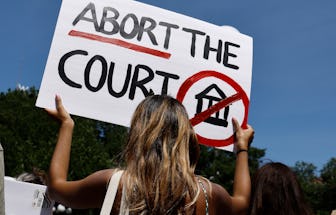 NEW YORK, NEW YORK - JULY 04: A woman holds up a sign in Union Square during a demonstration against...