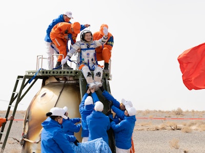 EJIN BANNER, CHINA - APRIL 16: Astronaut Zhai Zhigang waves as he is helped to disembark from the re...