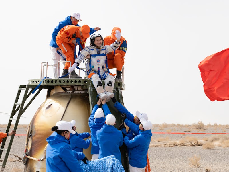 EJIN BANNER, CHINA - APRIL 16: Astronaut Zhai Zhigang waves as he is helped to disembark from the re...