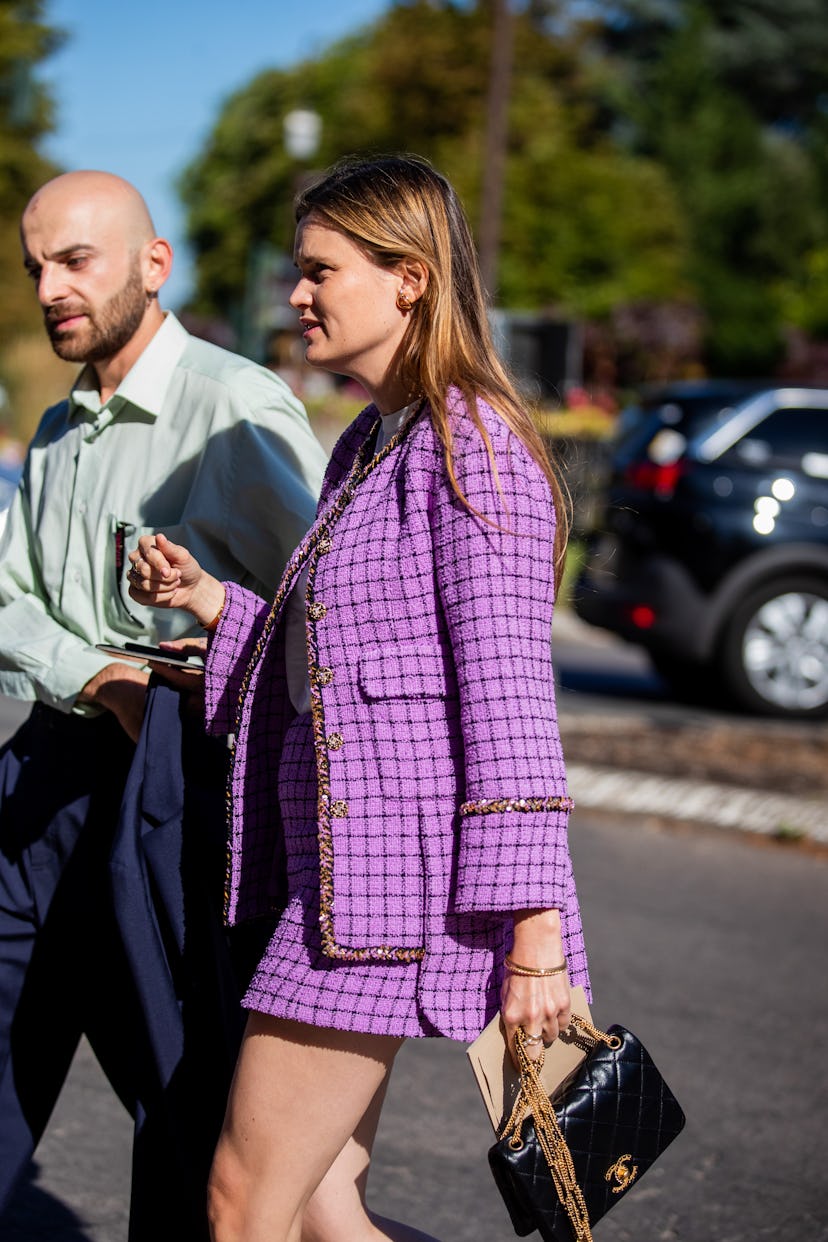 PARIS, FRANCE - JULY 05: A guest is seen wearing pink checkered blazer, skirt, black bag outside Cha...