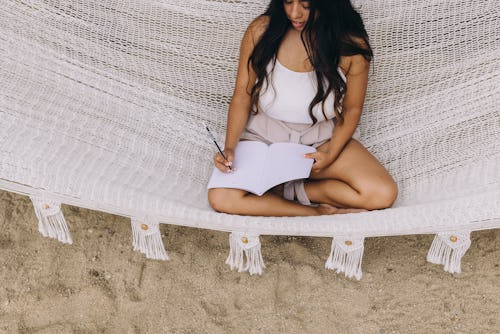 Mexico, Baja California, Todos Santos - November 16, 2021: Young latina woman in her 20s working fr...