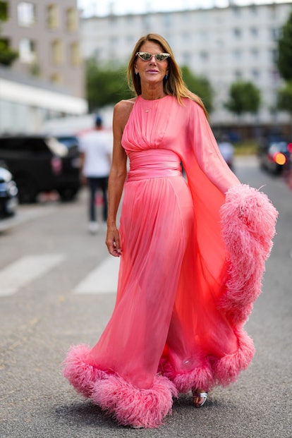 PARIS, FRANCE - JULY 05: Anna Dello Russo wears cat eyes sunglasses, silver earrings, a gold pendant...