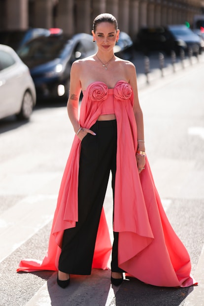 PARIS, FRANCE - JULY 04: Chiara Ferragni seen wearing gold pendant necklaces, a pink shiny satin off...