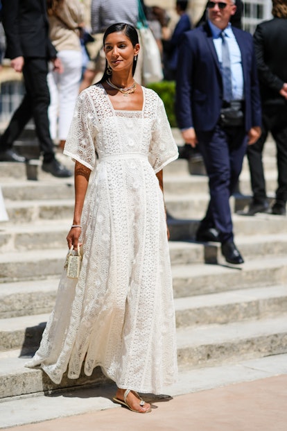 PARIS, FRANCE - JULY 04: A guest wears gold pendant earrings, a gold chain necklace from Dior, a sil...