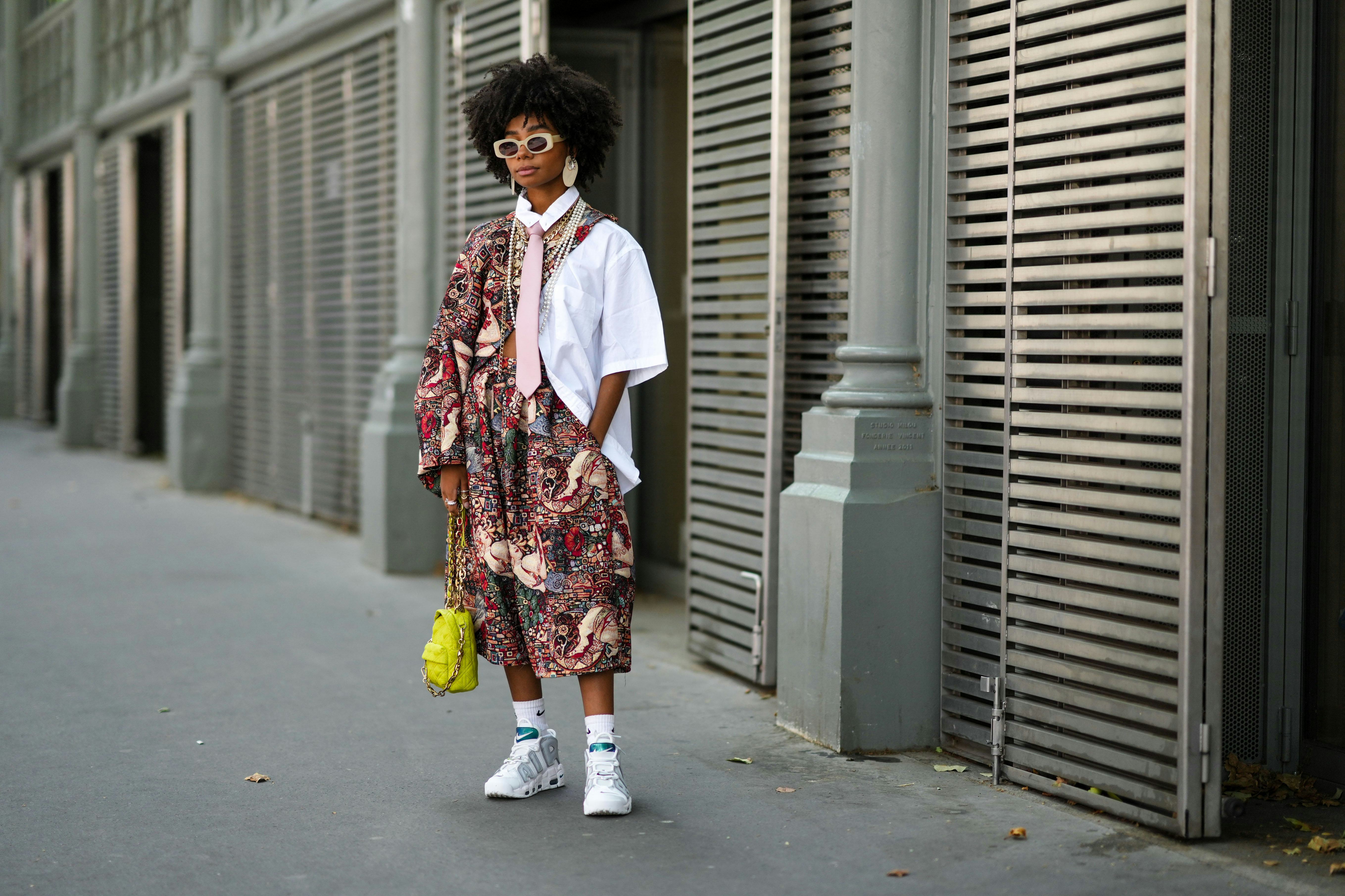 PARIS, FRANCE - JULY 06: Sarah Monteil wears beige sunglasses, beige large earrings, a white oversiz...