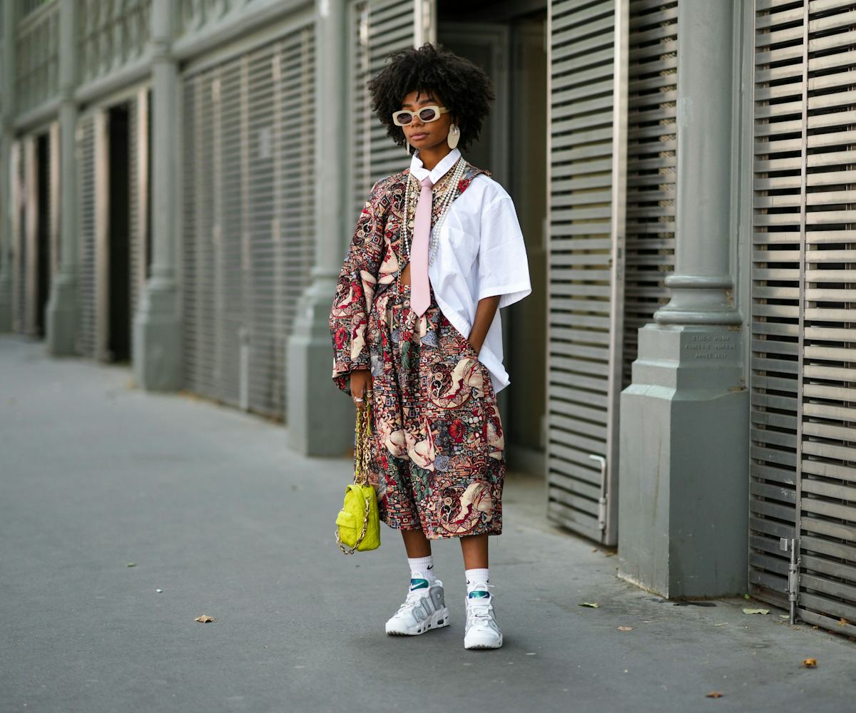 PARIS, FRANCE - JULY 06: Sarah Monteil wears beige sunglasses, beige large earrings, a white oversiz...