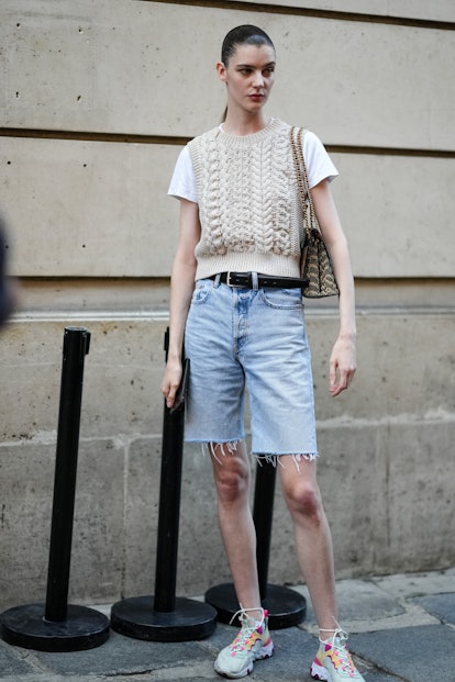 PARIS, FRANCE - JULY 03: A model wears a white short sleeves t-shirt, a beige braided wool sleeveles...