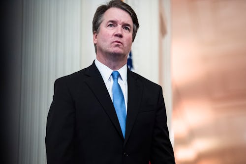 WASHINGTON, DC - OCTOBER 8 : Associate Justice Brett Kavanaugh listens as President Donald J. Trump ...