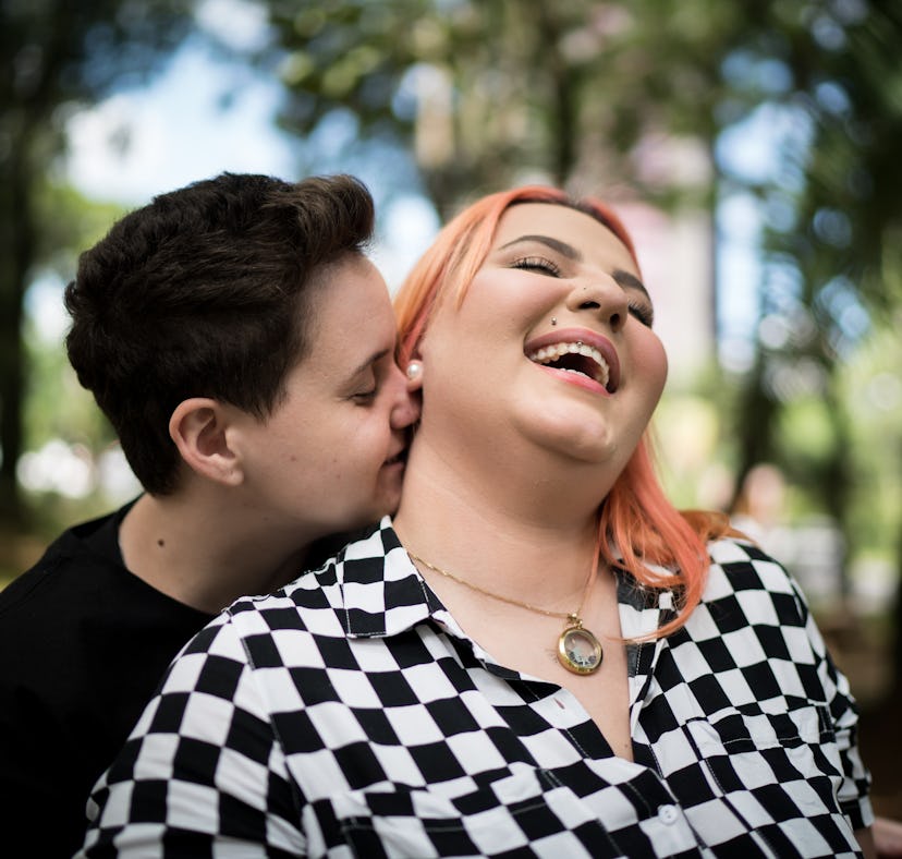 Lesbian couple embracing at park