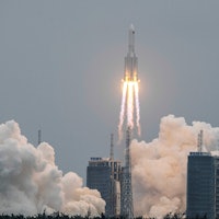 A Long March 5B rocket, carrying China's Tianhe space station core module, lifts off from the Wencha...
