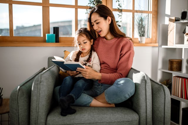 A young mother teaching her child how to read.