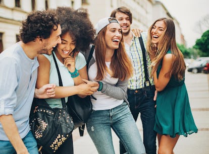 Multi-ethnic group of people walking and having fun outdoors in the city