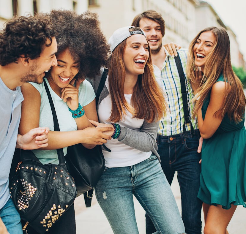 Multi-ethnic group of people walking and having fun outdoors in the city