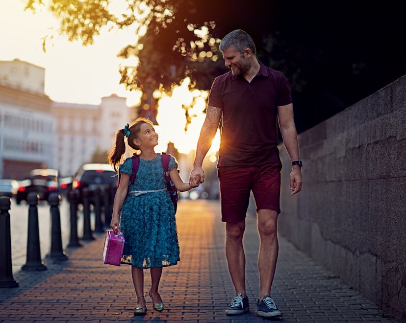 Father and daughter are returning from school