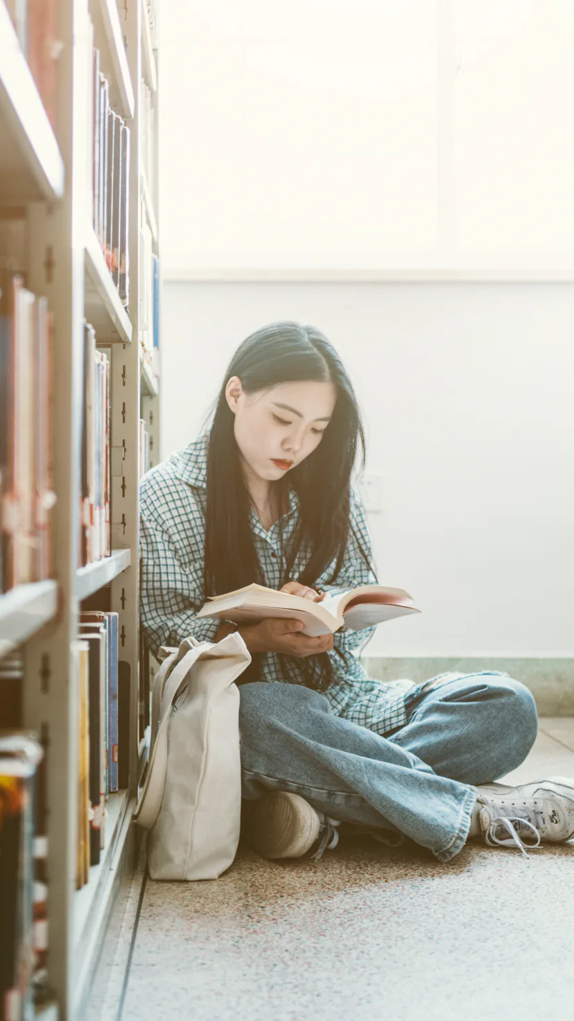 Girls choosing books and study in library