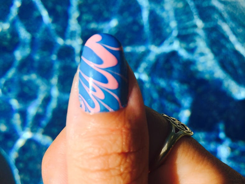 You can DIY swirl nails like these blue and pink swirl nails at home for under $20