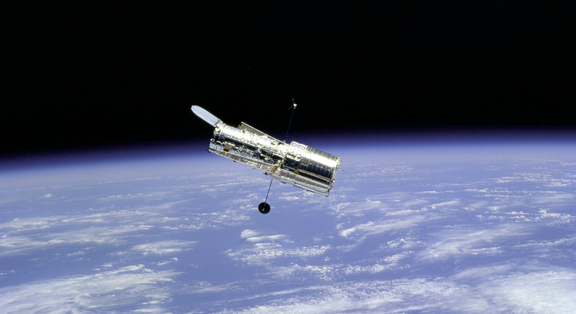 Hubble Space Telescope and Earth Limb, 1997. Flyaround of the Hubble Space Telescope (HST) after dep...