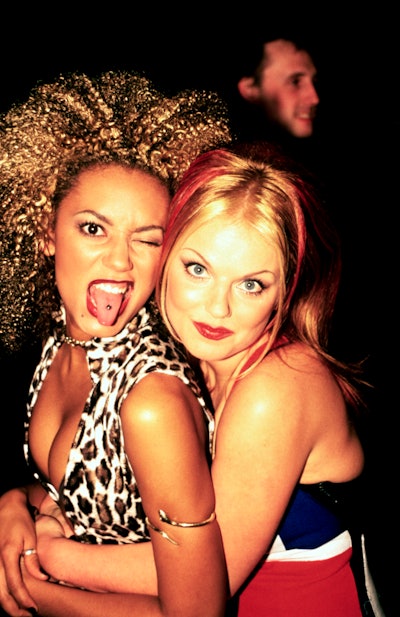 Mel B and Geri Halliwell of the Spice Girls. Mel B is wearing a tongue piercing