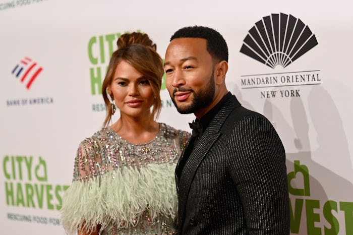 US model Chrissy Teigen (L) and husband US singer-songwriter John Legend attend the 2022 City Harves...