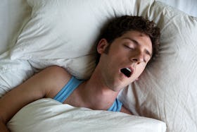 A man sleeping with his mouth open.