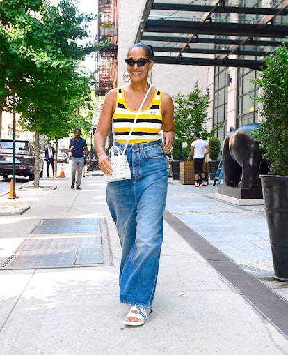 Tracee Ellis Ross wearing a Prada tank top and wide leg jeans in New York City.