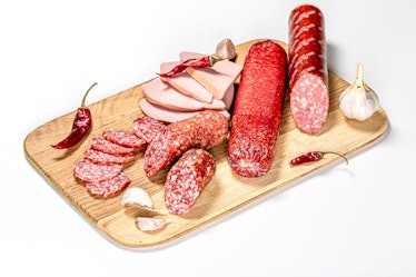 Salami and sausage on a wooden plate