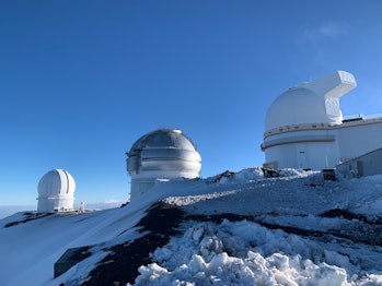 Morning winter view of the telescope on top of Mauna Kea on the Big Island of Hawaii, USA.  Dark skies, which...
