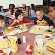 Four kids eating school lunches. California just became the first state to offer free breakfast and ...