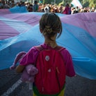 A child holds the transgender pride flag. A new study discredits the harmful notion that transgender...