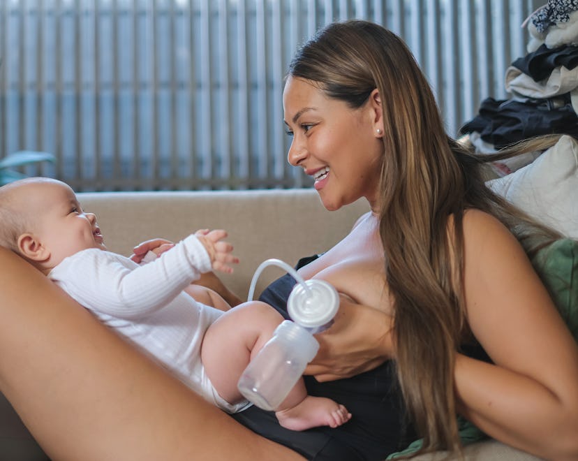mom using breast pump while wondering what to do with baby while pumping