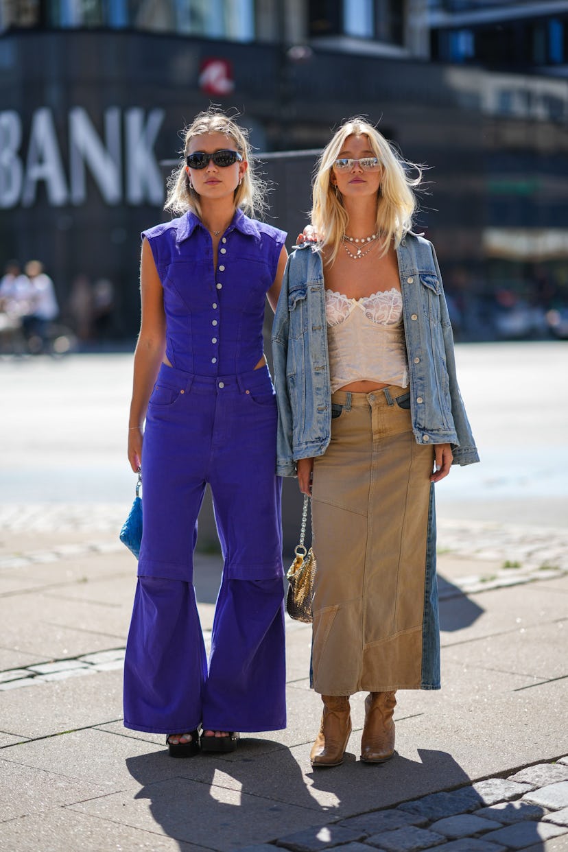 COPENHAGEN, DENMARK - AUGUST 10: A guest (L) wears black sunglasses, silver earrings, a neon purple ...