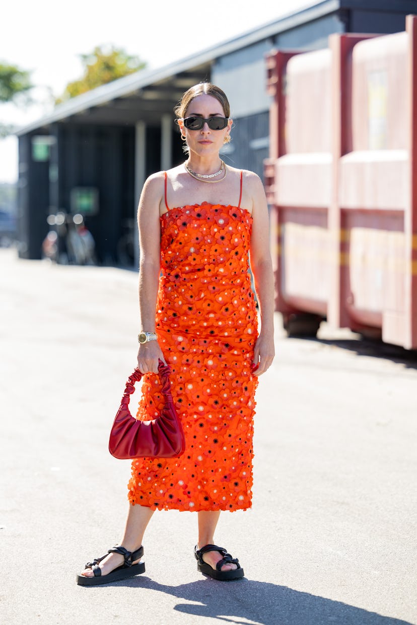 COPENHAGEN, DENMARK - AUGUST 10: Idalia Salsamendi seen wearing orange dress with glitter, red bag, ...
