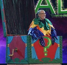 Rudy Giuliani dressed in the costume of a bird with colorful feathers, during Masked Singer