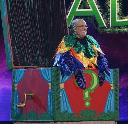 Rudy Giuliani dressed in the costume of a bird with colorful feathers, during Masked Singer