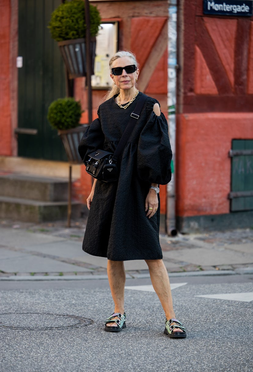 COPENHAGEN, DENMARK - AUGUST 10: A guest is seen wearing black dress, bag, sandals outside Baum & Pf...