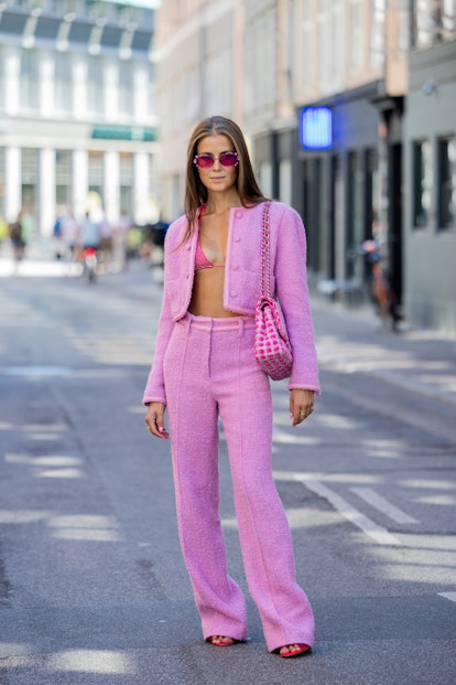 COPENHAGEN, DENMARK - AUGUST 12: Nina Sandbech is seen wearing pink cropped jacket, pants, Chanel ba...