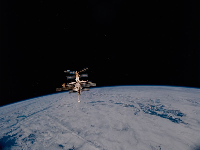 The Russian Space Station Mir backdropped against the darkness of space and the Planet Earth after M...