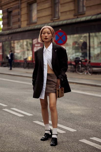 COPENHAGEN, DENMARK - AUGUST 09: A gueast wearing brown mini skirt, white shirt and dark blazer, whi...