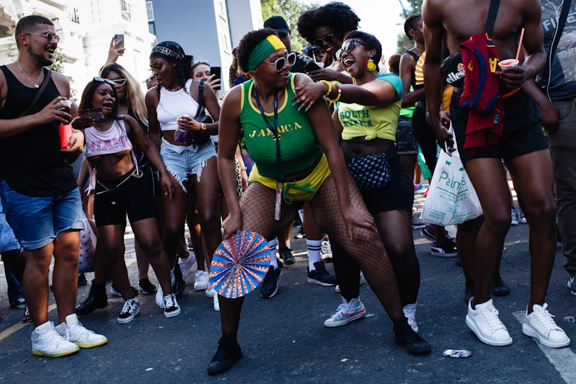 Revellers dance on Ladbroke Grove on the second and final day of the 2019 Notting Hill Carnival in L...