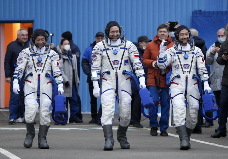 Russian cosmonaut Alexander Misurkin with Japanese billionaire Yusaku Maezawa and his assistant Yozo...