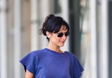 bella hadid wearing a blue t-shirt with white shorts and sunglasses 