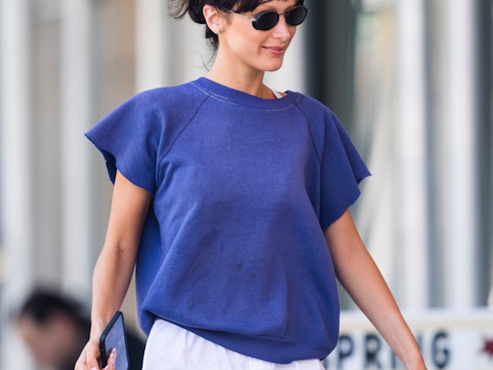 bella hadid wearing a blue t-shirt with white shorts and sunglasses 