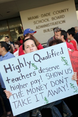 Teachers holding protest signs at the School Board Administration Building in Miami. 