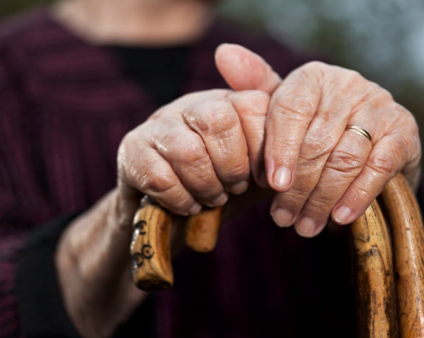 What's a toxic grandparent? Close-up of senior woman's hands holding her walking sticks.