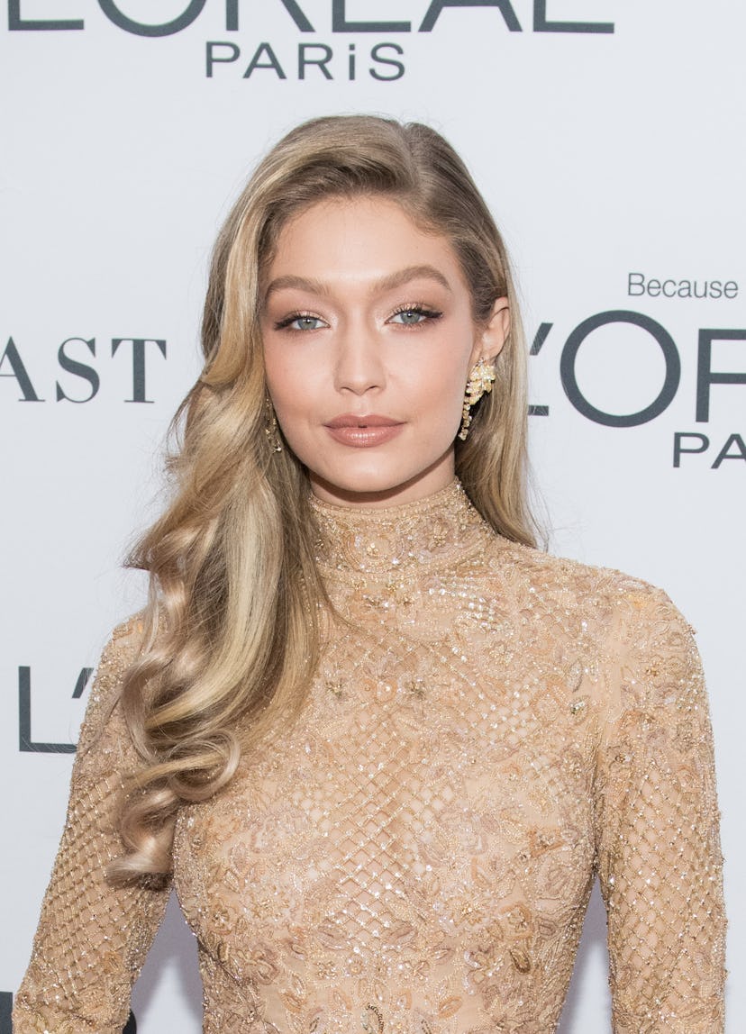 Gigi Hadid sporting a side part and flowing ringlets. 