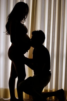 Silhouette of a person kissing a pregnant belly, how does sex induce labor, when to have it, best po...
