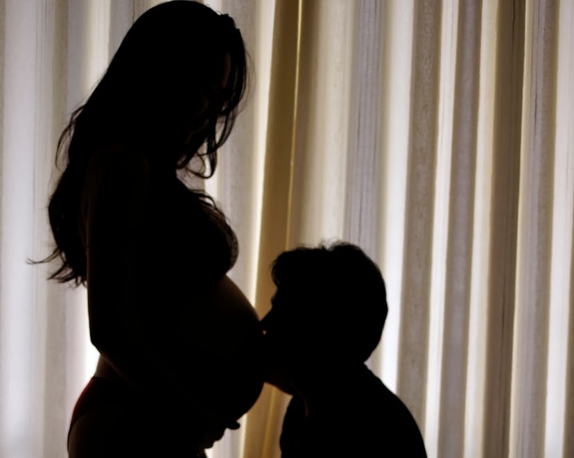 Silhouette of a person kissing a pregnant belly, how does sex induce labor, when to have it, best po...