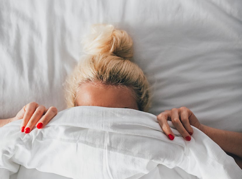 Woman trying a new lubricant in bed.
