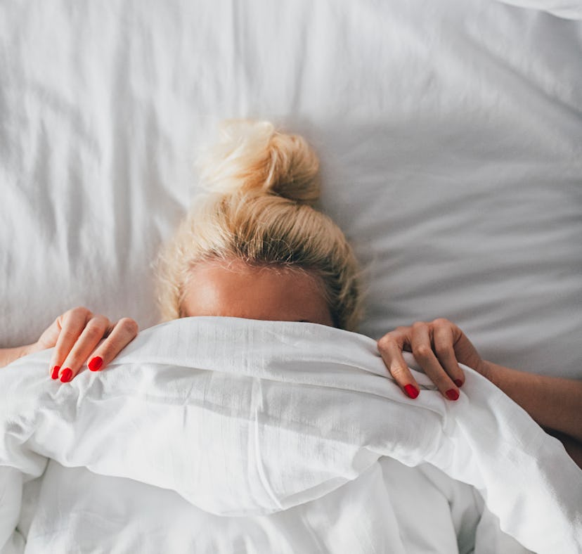 Woman trying a new lubricant in bed.